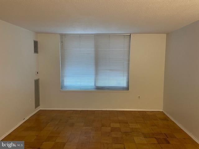1301 20th St NW Unit 316, Washington, DC 20036 - unfurnished room with baseboards and a textured ceiling