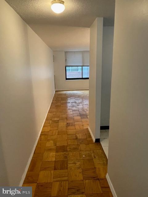 1301 20th St NW Unit 316, Washington, DC 20036 - hallway featuring a textured ceiling and baseboards