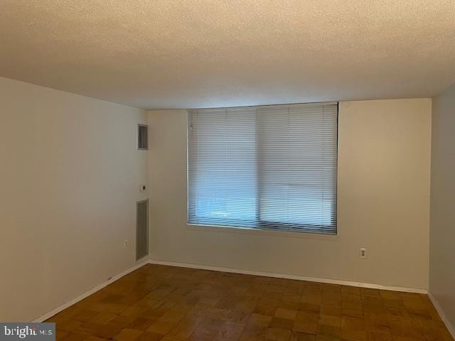 1301 20th St NW Unit 316, Washington, DC 20036 - spare room with a textured ceiling and baseboards