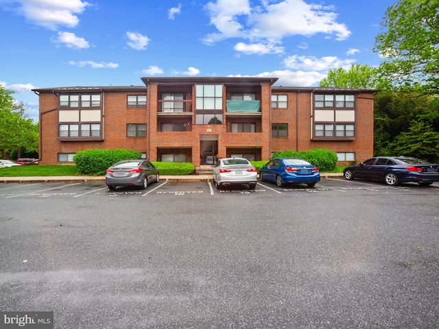 view of building exterior featuring uncovered parking