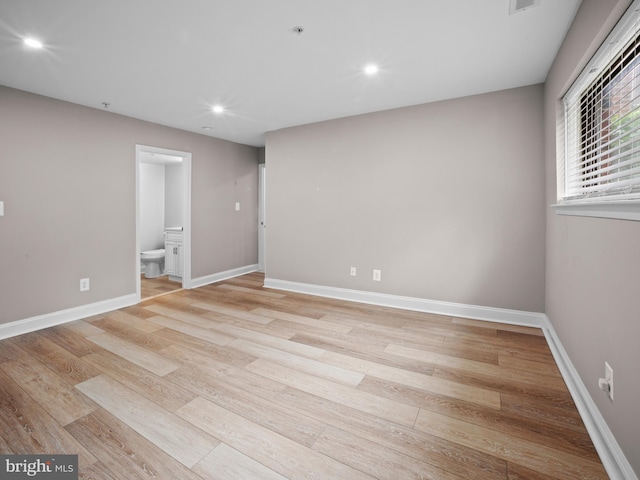 interior space featuring baseboards, visible vents, light wood-style flooring, and recessed lighting