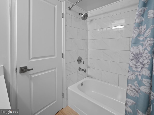 full bathroom with shower / bathtub combination with curtain and wood finished floors