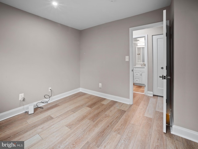 interior space featuring baseboards and light wood-style flooring