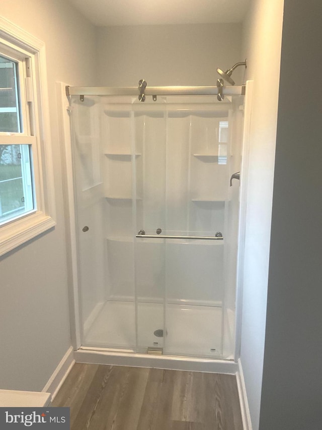 54 Bryan Dr, Rehoboth Beach, DE 19971 - bathroom with a stall shower, baseboards, and wood finished floors