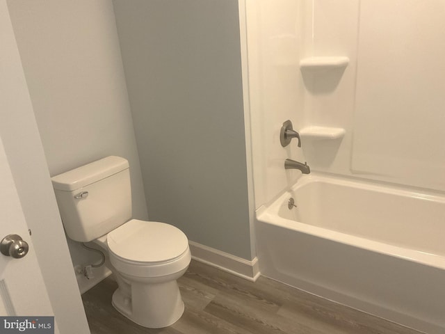 54 Bryan Dr, Rehoboth Beach, DE 19971 - bathroom featuring baseboards, wood finished floors, bathtub / shower combination, and toilet