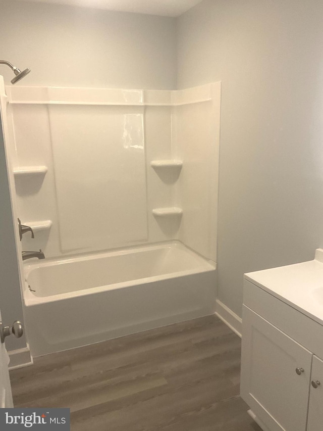 54 Bryan Dr, Rehoboth Beach, DE 19971 - full bath with baseboards, tub / shower combination, wood finished floors, and vanity