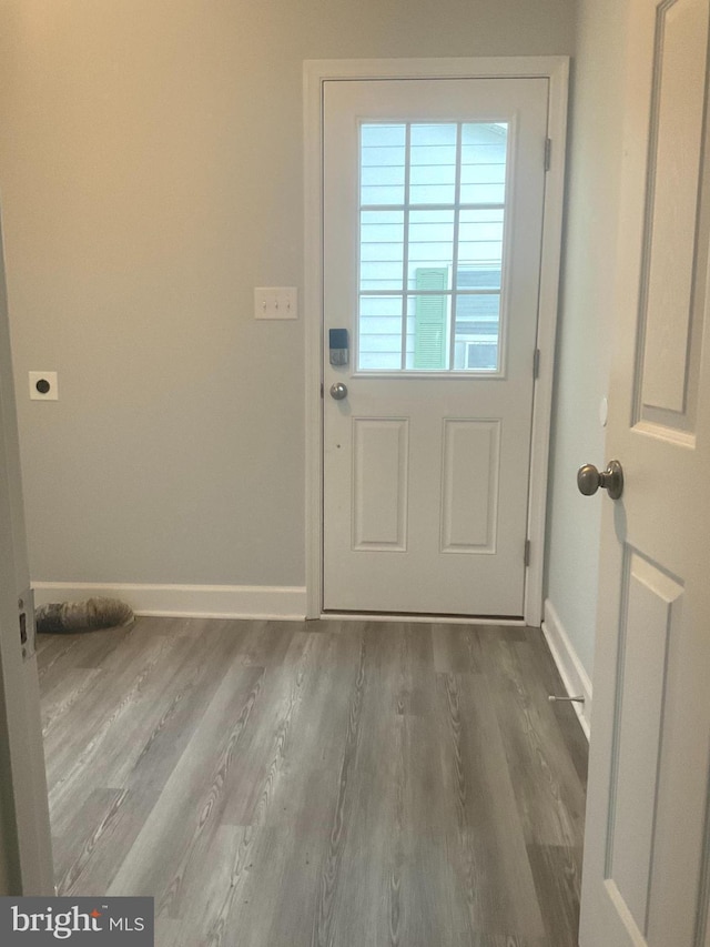 54 Bryan Dr, Rehoboth Beach, DE 19971 - doorway to outside featuring baseboards and wood finished floors