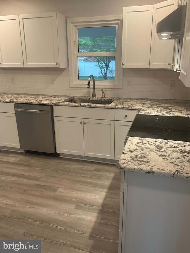54 Bryan Dr, Rehoboth Beach, DE 19971 - kitchen featuring stainless steel dishwasher, a sink, ventilation hood, decorative backsplash, and wood finished floors