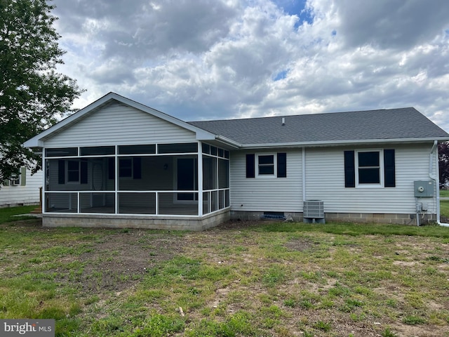 54 Bryan Dr, Rehoboth Beach, DE 19971 - rear view of property with a sunroom, central air condition unit, a shingled roof, and a yard