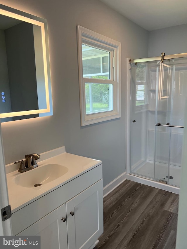 54 Bryan Dr, Rehoboth Beach, DE 19971 - bathroom with wood finished floors, a stall shower, vanity, and baseboards