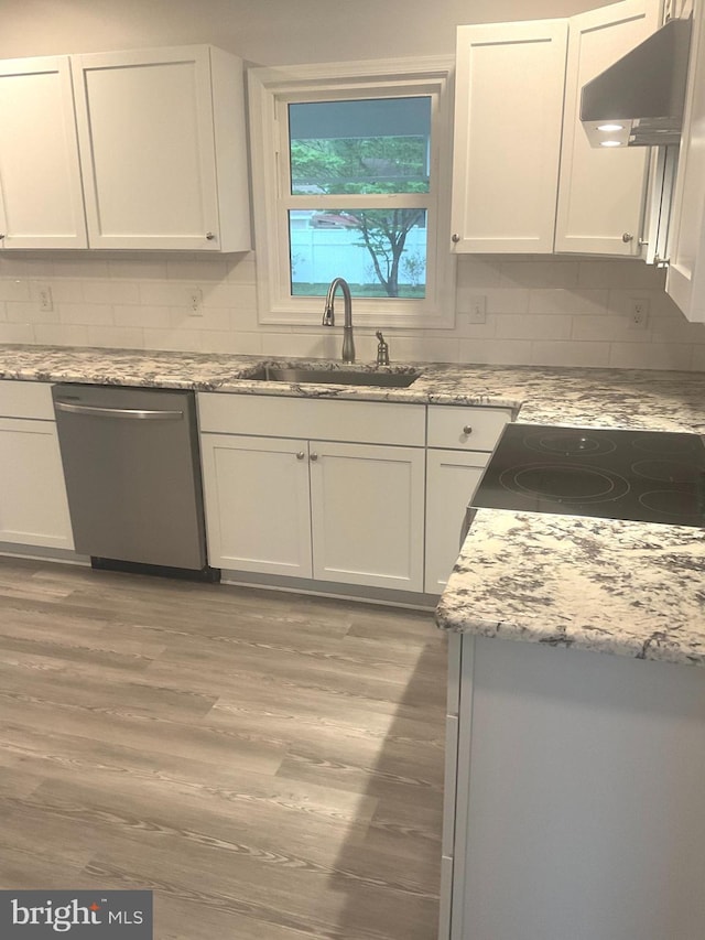 54 Bryan Dr, Rehoboth Beach, DE 19971 - kitchen featuring backsplash, stainless steel dishwasher, a sink, extractor fan, and light wood-style flooring