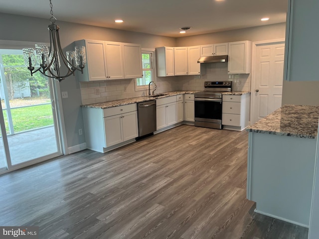 54 Bryan Dr, Rehoboth Beach, DE 19971 - kitchen with stainless steel appliances, under cabinet range hood, a chandelier, a sink, and white cabinetry