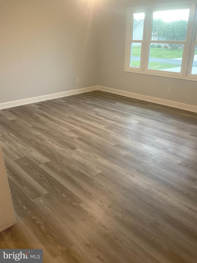 54 Bryan Dr, Rehoboth Beach, DE 19971 - empty room featuring baseboards and dark wood-style floors