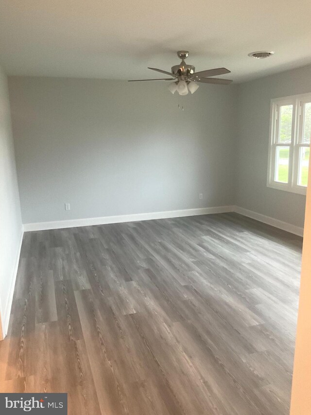 54 Bryan Dr, Rehoboth Beach, DE 19971 - spare room featuring ceiling fan, dark wood finished floors, and baseboards