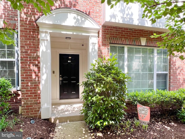 property entrance with brick siding