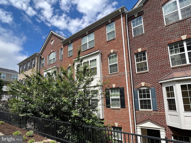 view of building exterior with fence