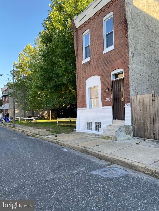 2718 W Sterner St, Philadelphia, PA 19132 - view of property with brick siding, fence, and entry steps