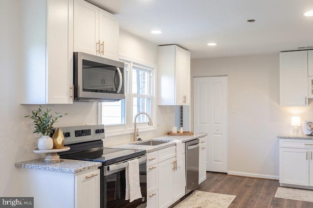 108 Wesley Chapel Dr, Edinburg, VA 22824 - kitchen featuring appliances with stainless steel finishes, a sink, dark wood-type flooring, white cabinets, and light stone counters