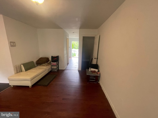 sitting room featuring baseboards and wood finished floors