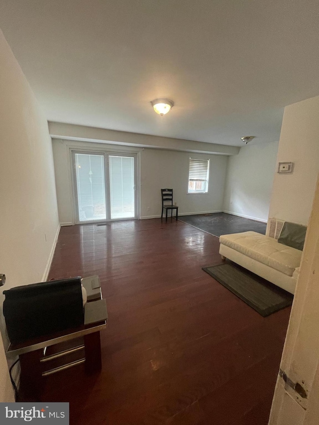 living room featuring baseboards and wood finished floors