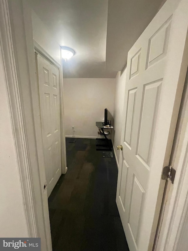 hallway featuring baseboards