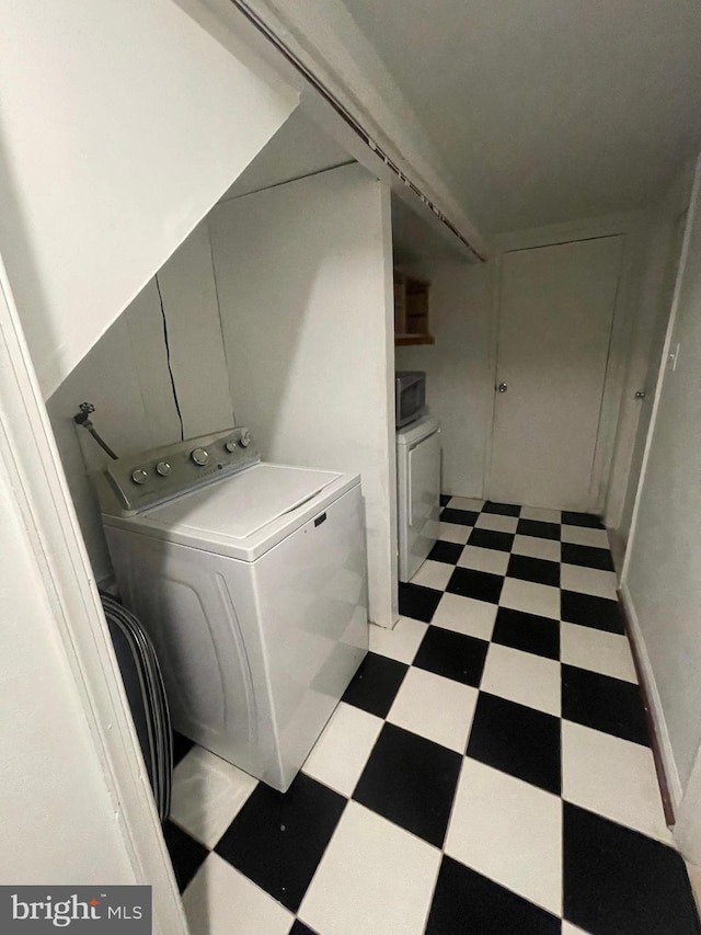 washroom with light floors and washer / clothes dryer
