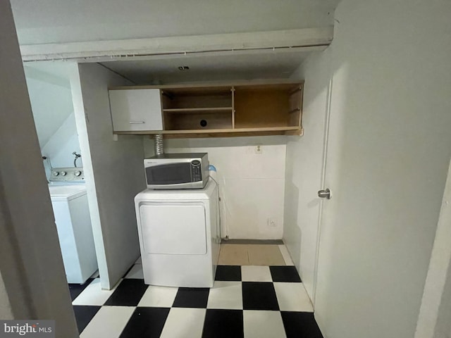 laundry area featuring laundry area, washer and clothes dryer, and light floors