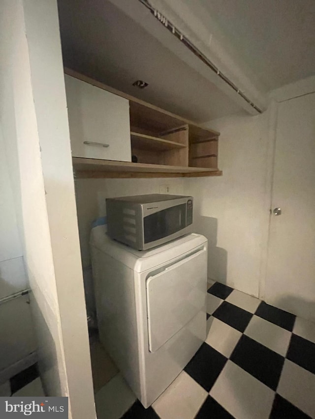laundry area featuring washer / clothes dryer, laundry area, and tile patterned floors