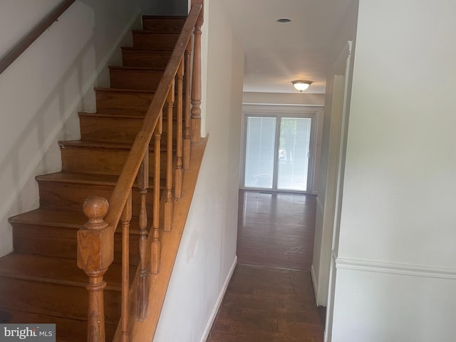 stairs with baseboards and wood finished floors