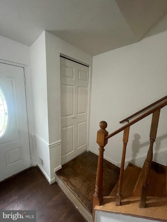 entryway featuring baseboards and wood finished floors