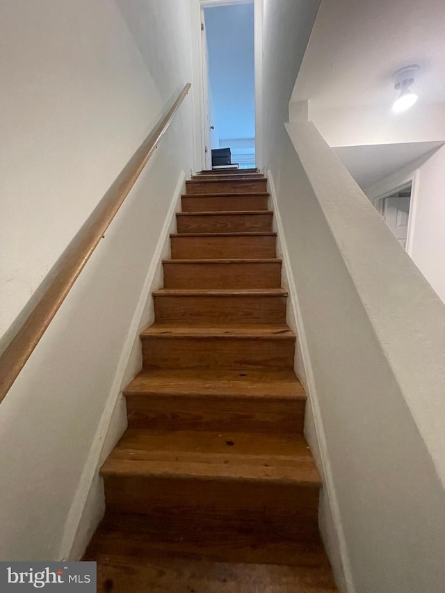 stairway with wood-type flooring