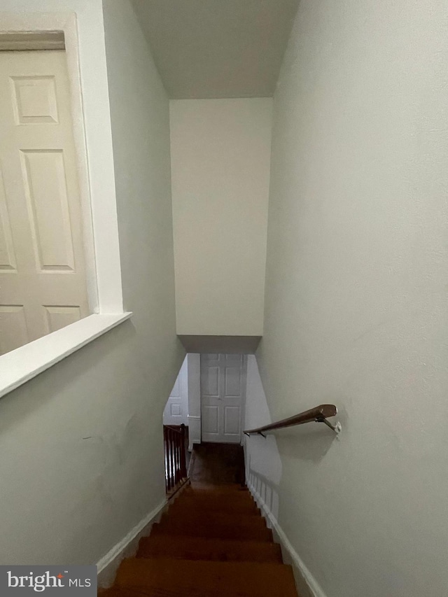 stairs featuring baseboards and wood finished floors