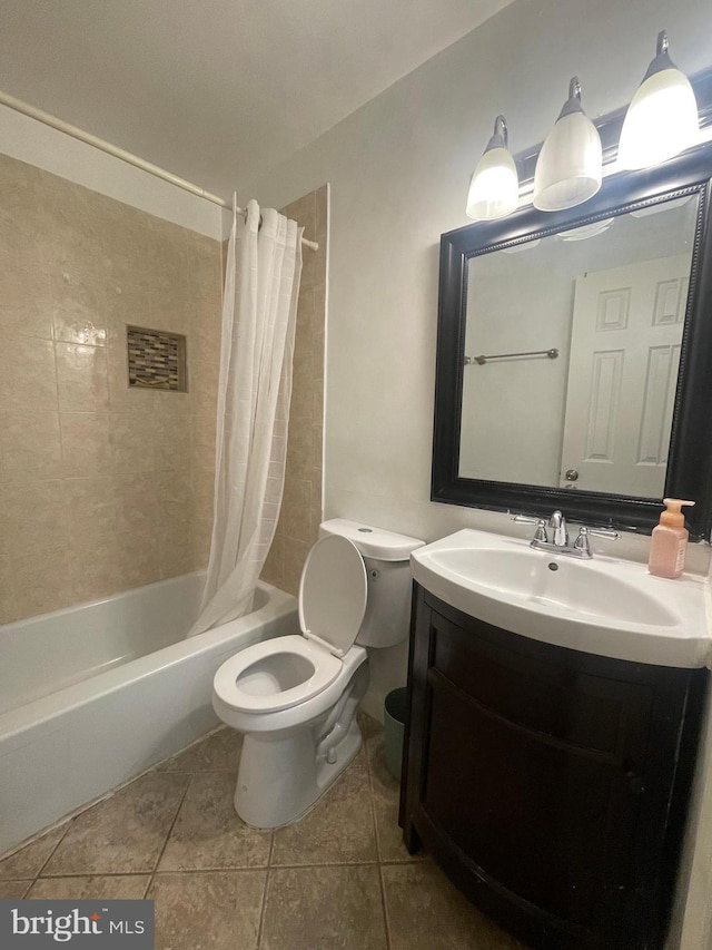 bathroom featuring vanity, tile patterned flooring, shower / bath combo with shower curtain, and toilet