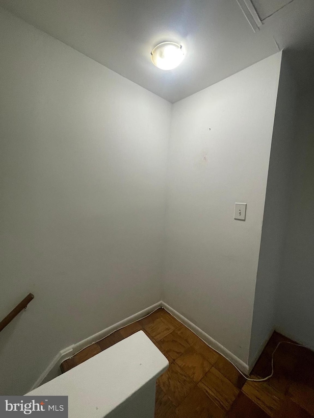 unfurnished room featuring baseboards