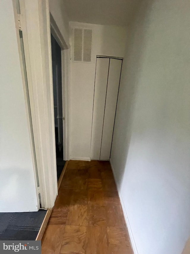 corridor featuring visible vents and baseboards