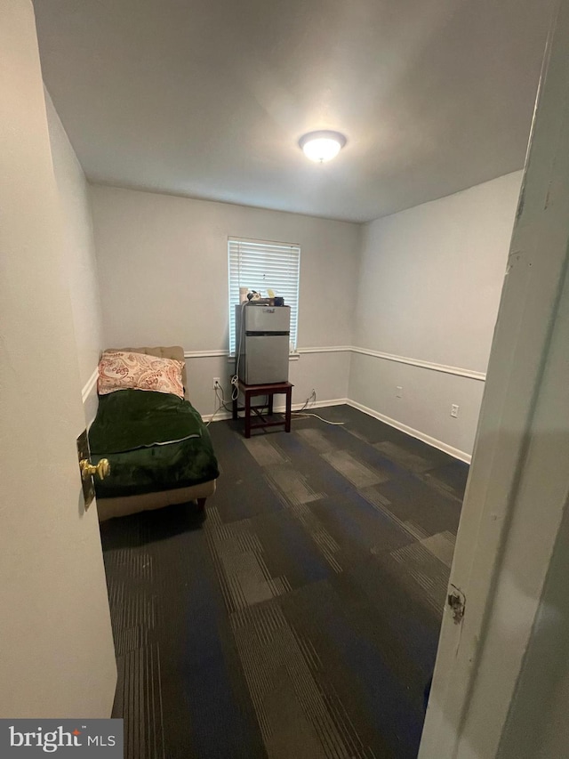 bedroom featuring dark colored carpet