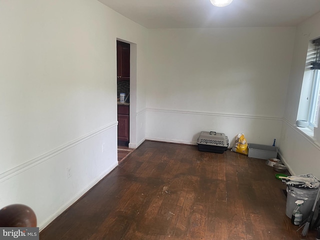 unfurnished dining area with baseboards and hardwood / wood-style floors