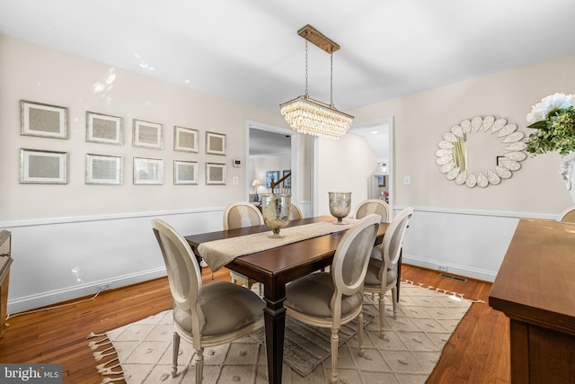 dining area featuring a chandelier and wood finished floors