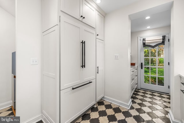 mudroom with tile patterned floors, recessed lighting, and baseboards