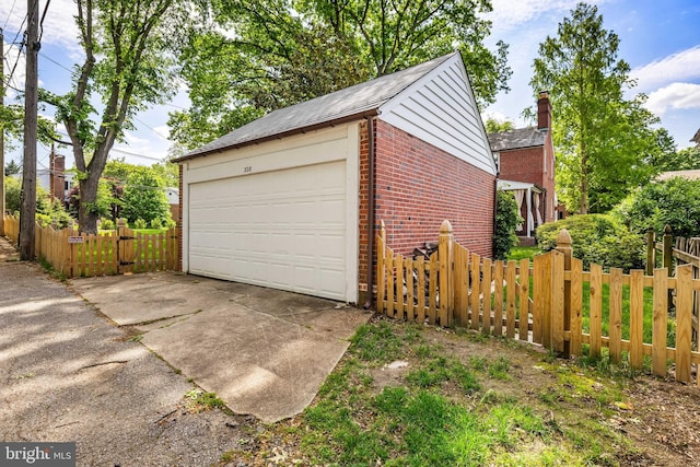 detached garage featuring fence