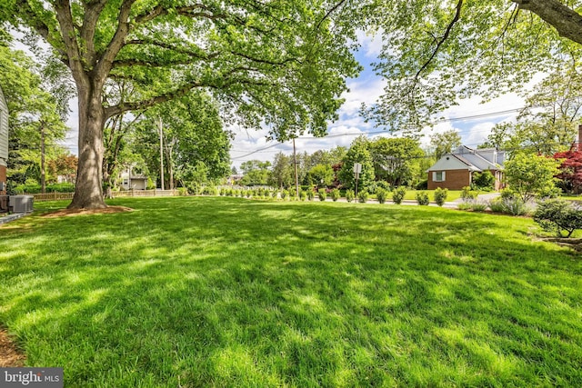 view of grassy yard with central AC unit
