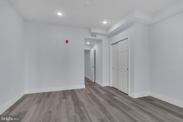 unfurnished room with recessed lighting, baseboards, visible vents, and wood finished floors