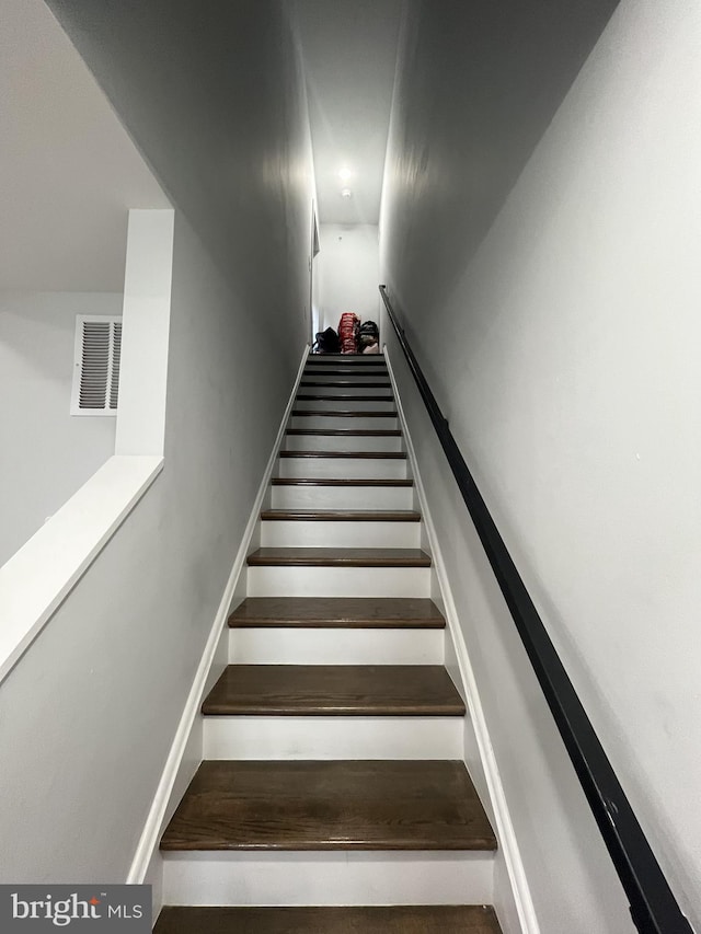 staircase featuring visible vents