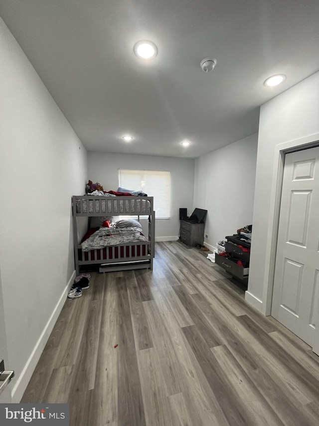 bedroom with baseboards, recessed lighting, and wood finished floors