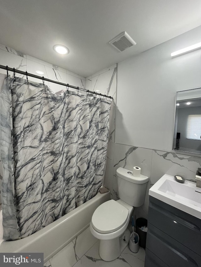 full bathroom with visible vents, marble finish floor, toilet, tile walls, and shower / bathtub combination with curtain