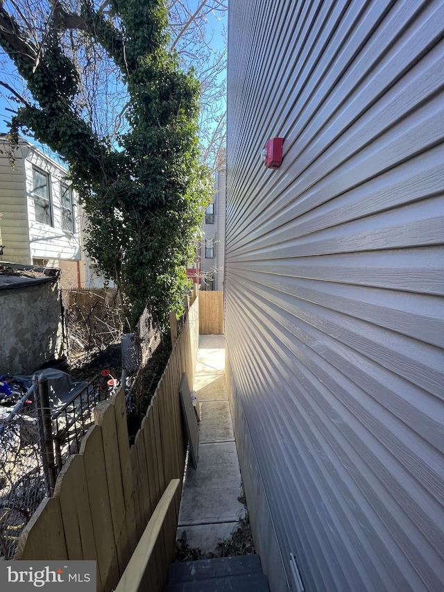 view of side of home featuring fence