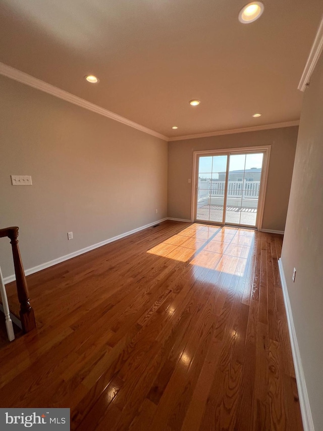 unfurnished room with crown molding, recessed lighting, baseboards, and wood finished floors