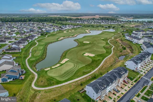 drone / aerial view with view of golf course, a water view, and a residential view