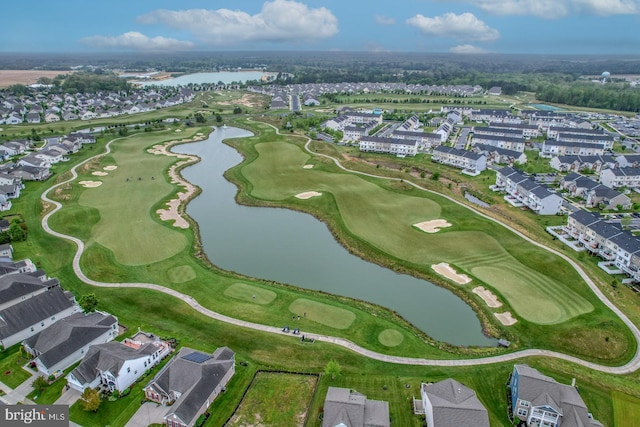 birds eye view of property with view of golf course, a water view, and a residential view