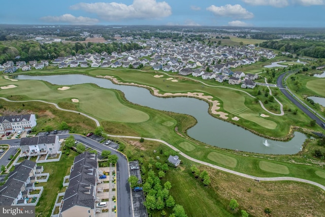 drone / aerial view with view of golf course, a water view, and a residential view